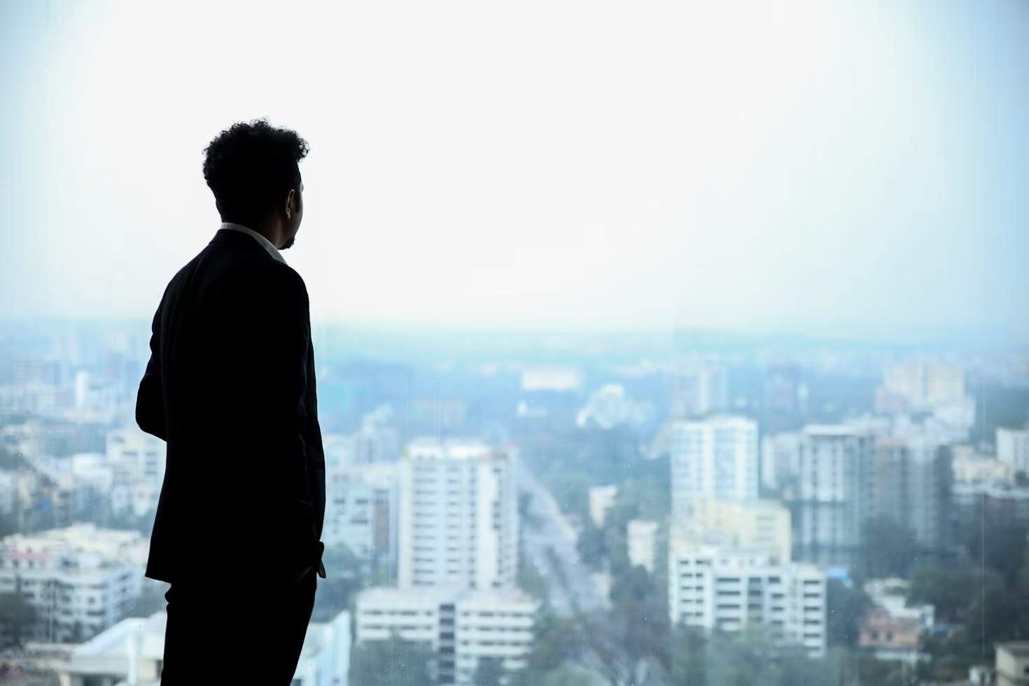a businessman looking out at the cityscape